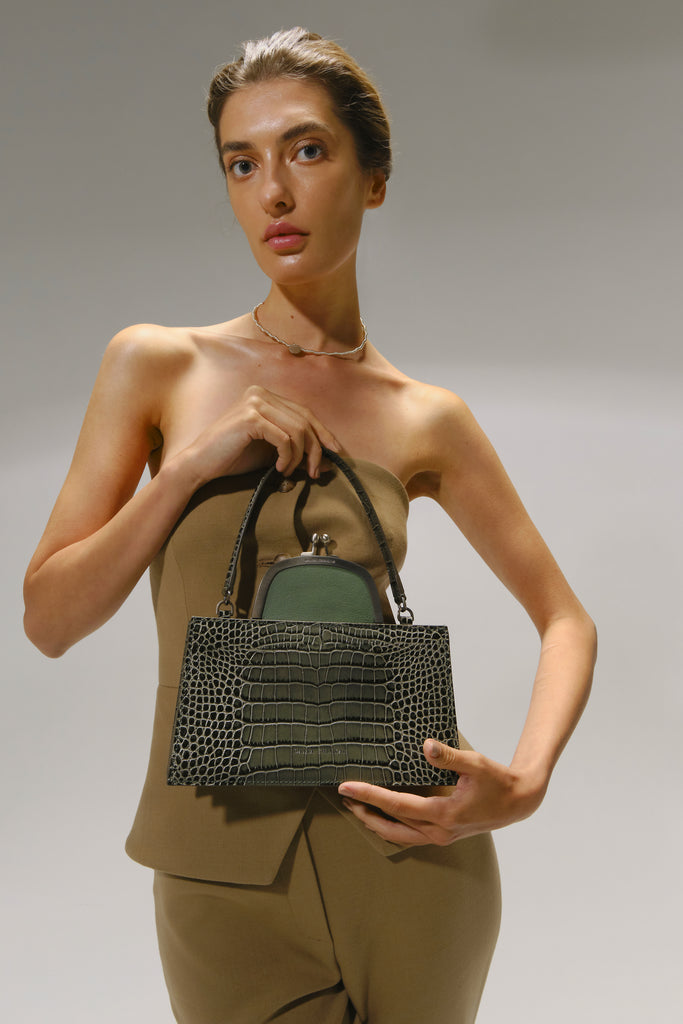 woman-holding-olive-croc-embossed-bag